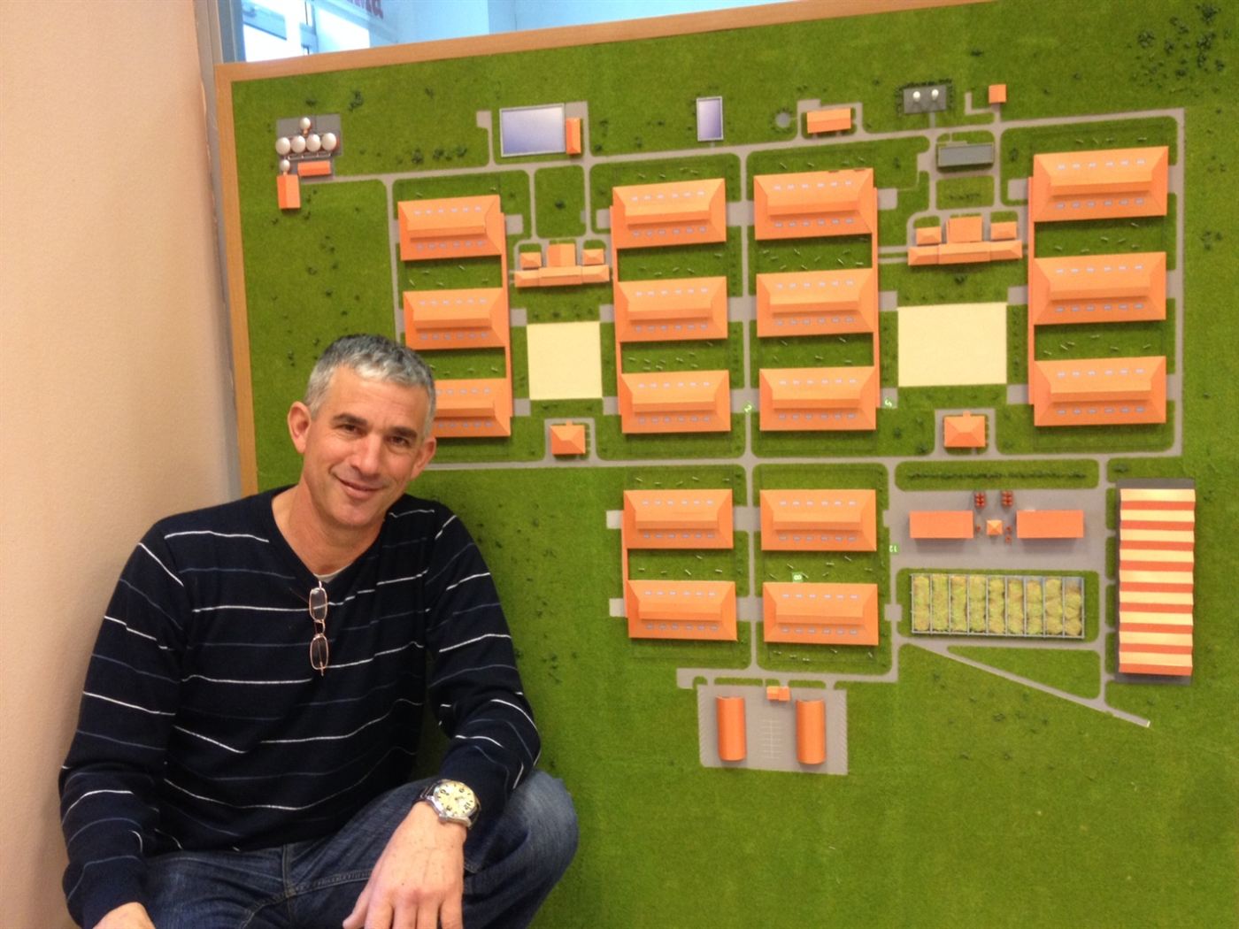 Ziv Matalon next to a dairy complex model